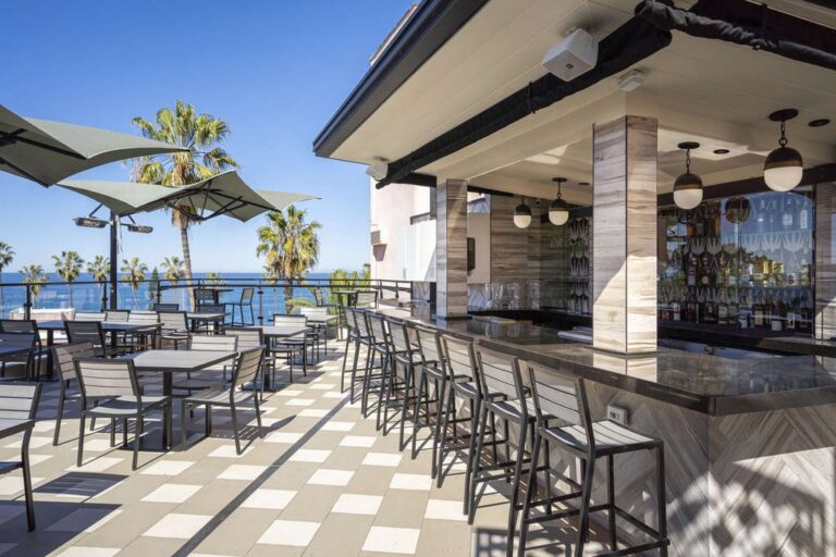 Shoreline Bar Stools and Shoreline Side Chairs on the rooftop bar at the Cormorant Hotel
